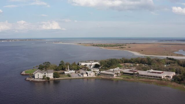 Close-up panning aerial shot of Fort Johnson with Fort Sumter in the distance in Charleston Harbor, South Carolina. 4K