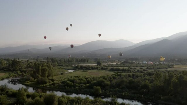 4K Aerial Drone Footage of Hot Air Balloons Flying over Steamboat Springs and the Yampa River Valley in Colorado