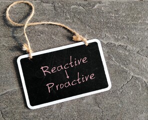 Chalkboard with text written PROACTIVE and REACTIVE , different traits - one focuses on eliminating...
