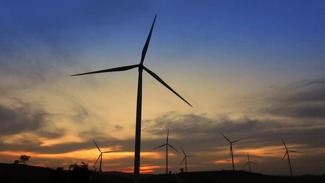 Green energy concept - Wind Turbine Generator in sunset.