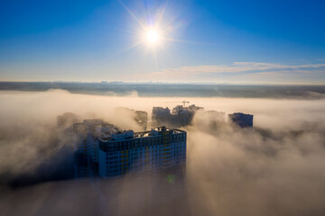 Fog-Blanketed Urban Landscape: Homes Peeking Through the Mist - 773934480