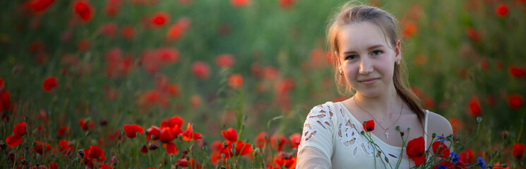 Poppies and Poetry: Girl Finding Inspiration in Nature - 773934619