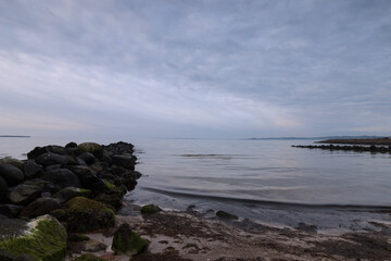 Fototapeta na wymiar Scenic seascape with stone piers and tranquil coastal scenery..