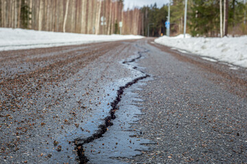 Big crack in asphalt road closeup