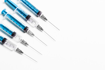 Medical disposable syringe on a white background. Supplies for injection and virus protection