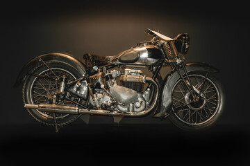 Vintage retro motorcycle rebuild on black background. Old morocycle with scratches of rust.