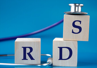 RDS - acronym on wooden large cubes on blue background with stethoscope