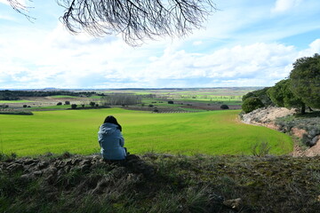 Woman sitting contemplating the landscape