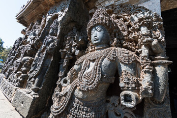Close up of an ornate sculpture of a Dwarapala (gatekeeper) at the entrance to the ancient Hoysaleshwara temple complex in Halebidu in Karnataka.