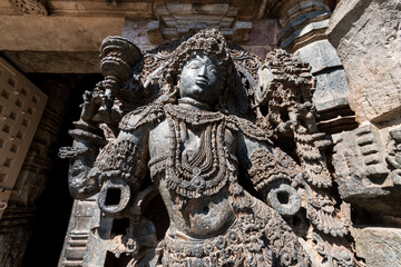 An ornate sculpture of a Dwarapala (gatekeeper) at the entrance to the ancient Hoysaleshwara temple complex in Halebidu in Karnataka.
