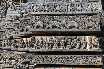 Beautiful stone carvings on the wall of the ancient Hoysaleshwara temple in Halebeedu in Karnataka.