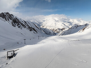 Fototapeta na wymiar Kudebi, Bidara, Sadzele, Kobi aerial panorama in caucasus winter mountains. Aerial drone view of Gudauri ski resort in winter. Caucasus mountains in Georgia
