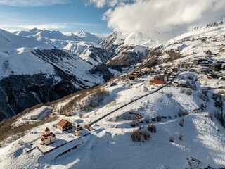 Aerial drone view of Gudauri ski resort in winter. Caucasus mountains in Georgia. Amaglebis eklesia...