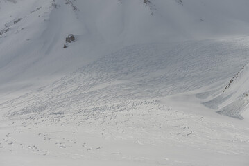Freeride rally traces on powder snow. Aerial drone view of Gudauri ski resort in winter. Caucasus mountains in Georgia.  Kudebi, Bidara, Sadzele, Kobi aerial panorama in caucasus winter mountains.