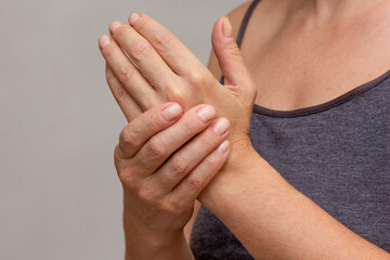 Woman hands showing numb hand over cropped body