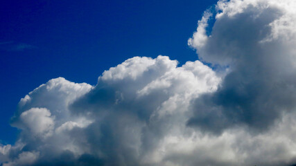 A huge white cloud. View of cumulus clouds against a blue sky.