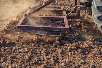 Harrowing with a tractor to thin the soil. cultivation of the soil seen in close-up