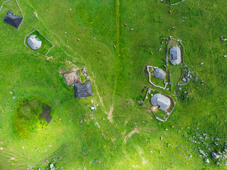 Aerial View of Mountain Cottages on Green Hill of Velika Planina Big Pasture Plateau, Alpine Meadow Landscape, Slovenia - 773971621