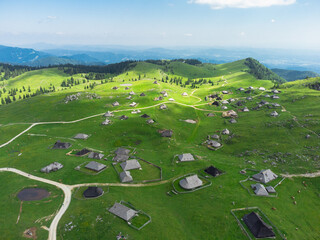 Aerial View of Mountain Cottages on Green Hill of Velika Planina Big Pasture Plateau, Alpine Meadow Landscape, Slovenia - 773971679