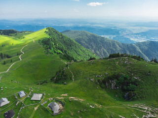 Aerial View of Mountain Cottages on Green Hill of Velika Planina Big Pasture Plateau, Alpine Meadow Landscape, Slovenia - 773971696