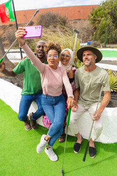 Diverse friends taking a selfie at a mini golf course