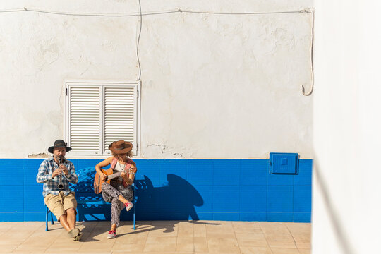 Street Music Duo Performing in Sunlit Town Square