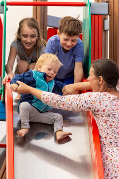 Joyful family time at the playground with baby and kids