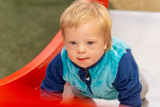 Toddler with Down Syndrome Enjoying Playground Time