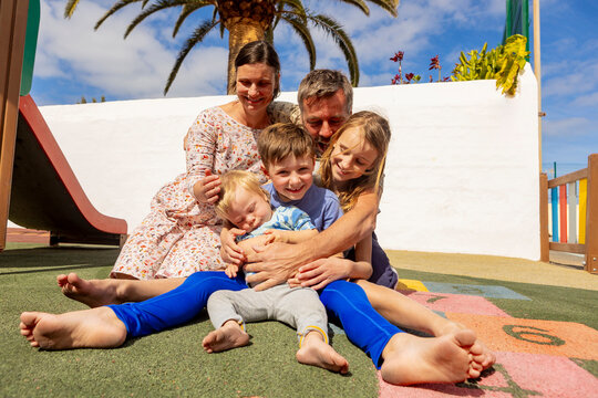 Family bonding time at a playground on a sunny day - Powered by Adobe