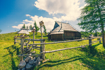 Traditional Mountain Wooden Shepherd Shelters on Big Pasture Plateau or Velika Planina in Slovenia - 773973037