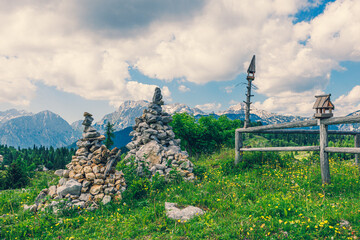 Old Wooden Fence and Pile of Stones. Mountains in the Background in Velika Planina, Slovenia - 773974041
