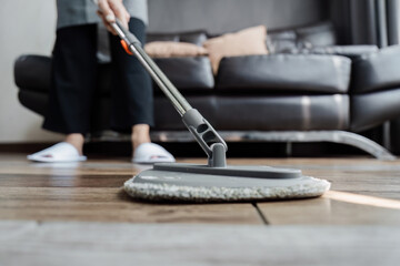 cleaning service housekeeper women swipe floor in living room. House cleaning service concept