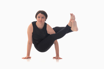 Astavakrasana, Ashtanga yoga  Side view of woman wearing sportswear doing Yoga exercise.