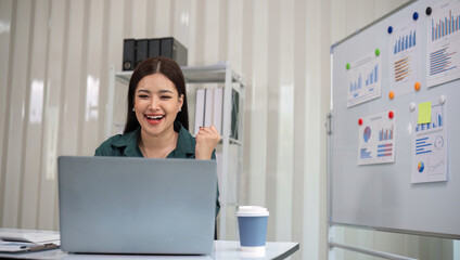 Beautiful business woman with determination Working on laptop in modern office