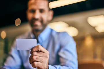 A businessman holding a credit card and entering data in the laptop.