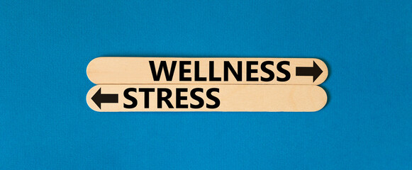 Wellness or stress symbol. Concept word Wellness or Stress on beautiful wooden stick. Beautiful...