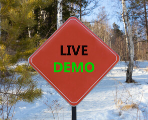 Live demo symbol. Concept words Live demo on beautiful red road sign. Beautiful forest snow blue...