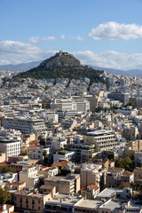 Picturesque view from Acropolis hill on Mount Lycabettus and the city skyline on a sunny day,...