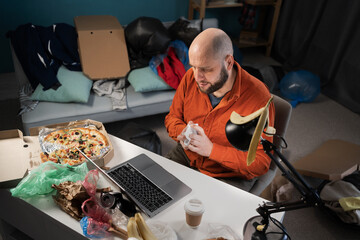 Caucasian male freelancer working on Messy and cluttered home office desk