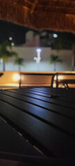 image of dark table in garden with pool at night
