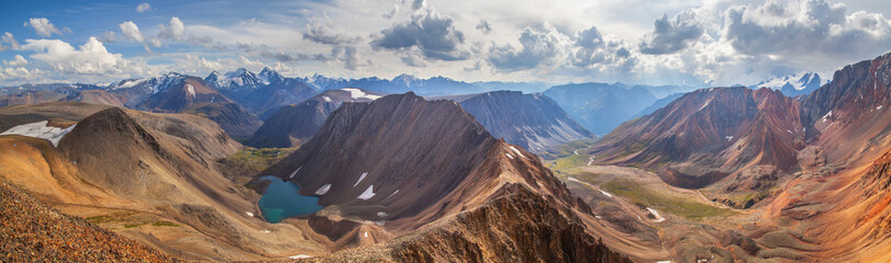 The turquoise lake in the mountain gorge, the colored mountains, panoramic, Altai