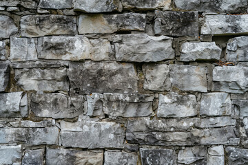 A stone wall built with rocks of various sizes, creating a solid and durable structure