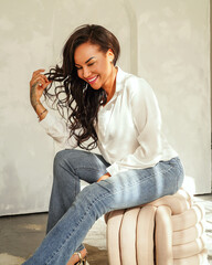 Beautiful woman posing in jeans and white shirt, smiling. Casual daily style. - 773996868