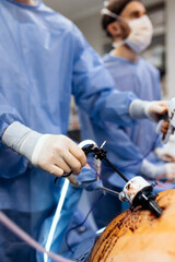 A group of medical surgeons in the operating room during an operation. A patient on the operating...