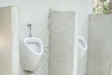 Row of outdoor urinals men public toilet.
