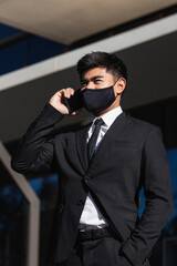 smart attractive asian male businessman wearing face mask virus protecting working with smartphone