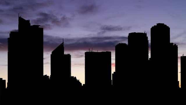 Manila: the capital of the Philippines, Time Lapse at Twilight with Colourful Sky and Dark Silhouette of Skyscrapers