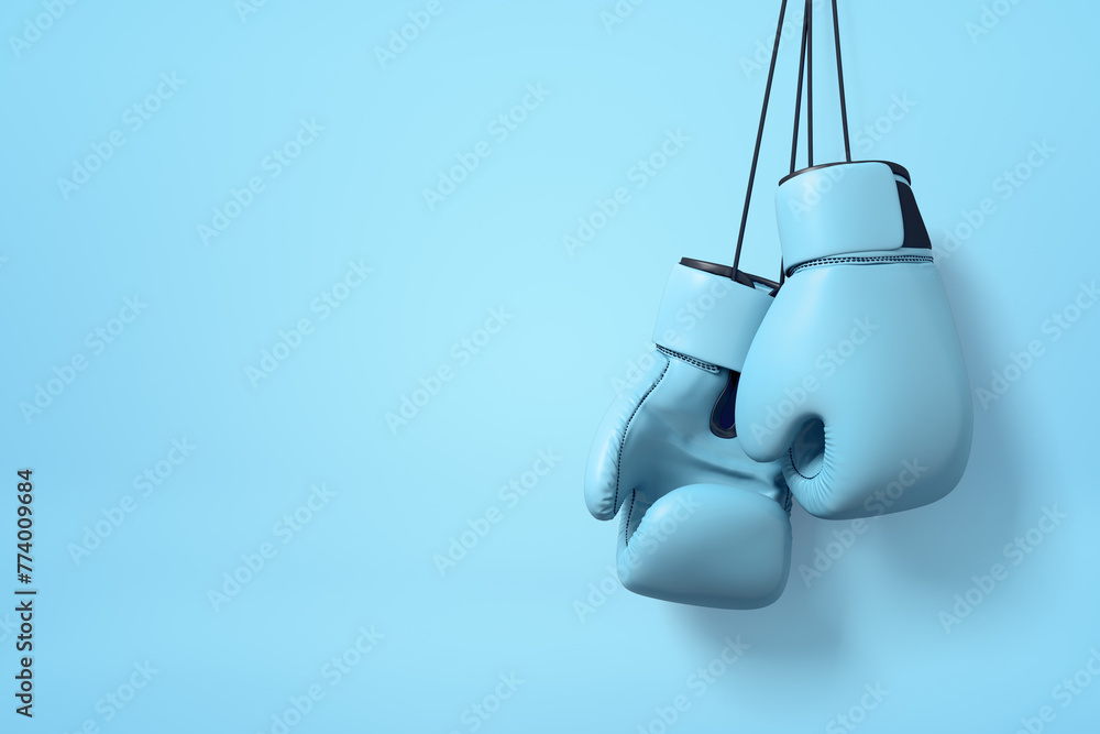 Aufkleber 3d close-up rendering of pair of light blue boxing gloves hanging on string on light pink background