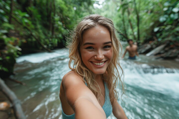 Joyful Woman Taking a Selfie in Tropical Rainforest by Waterfall