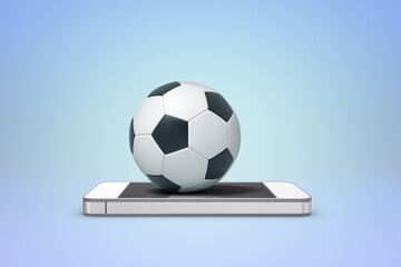 Soccer ball resting on mobile phone